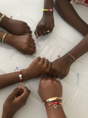 Group shot of hands and friendship bracelets